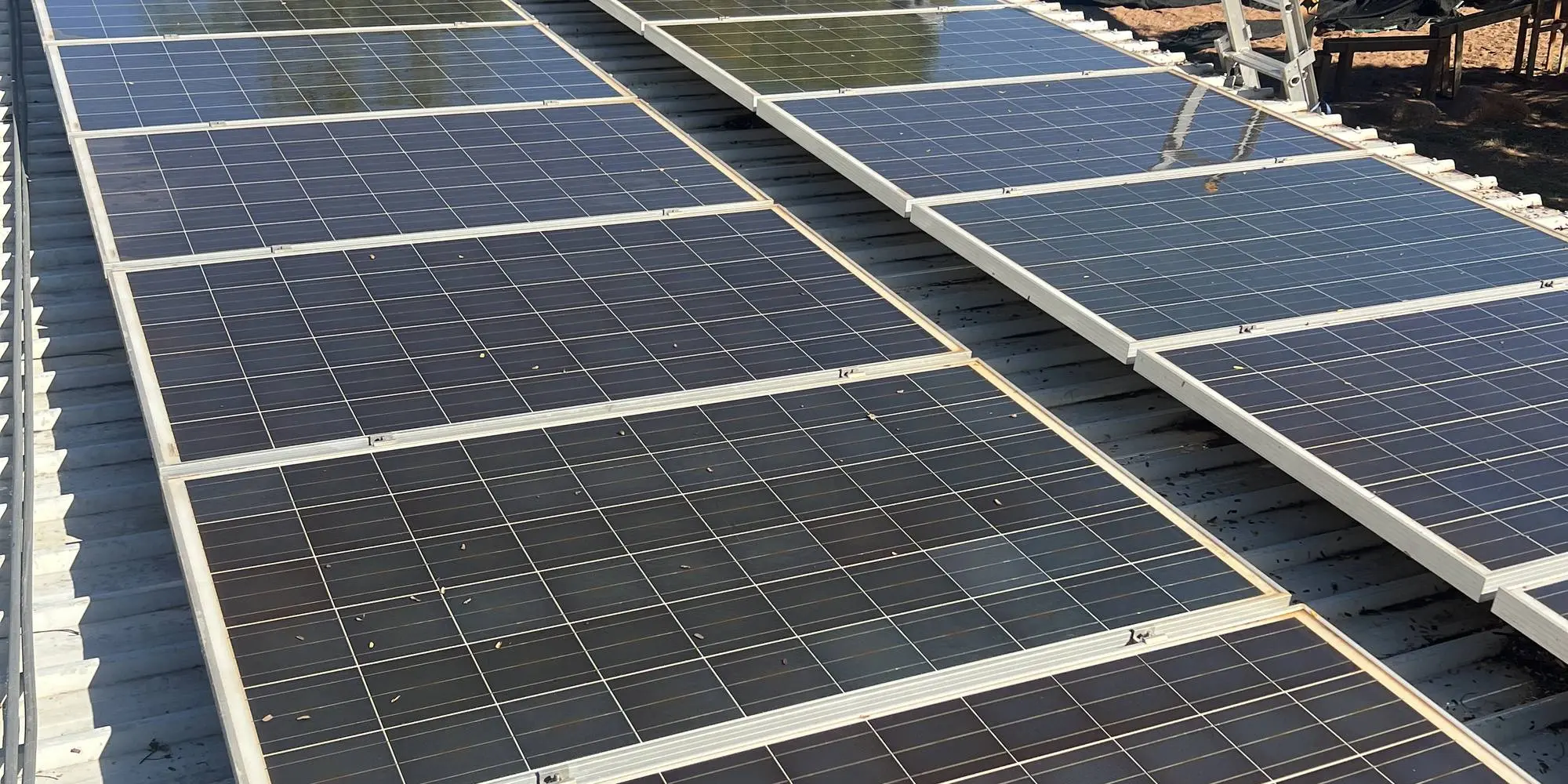 Rows of solar panels on a metal roof after cleaning with deionised water