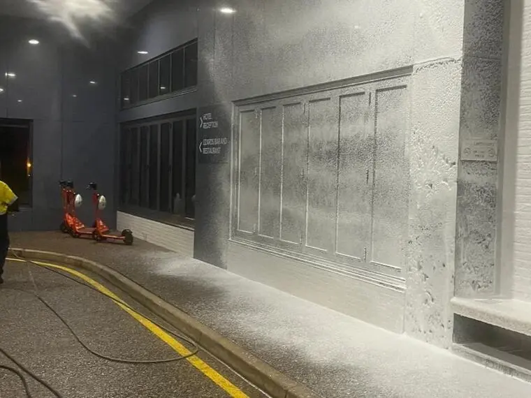 A warehouse floor part way through an industrial pressure clean